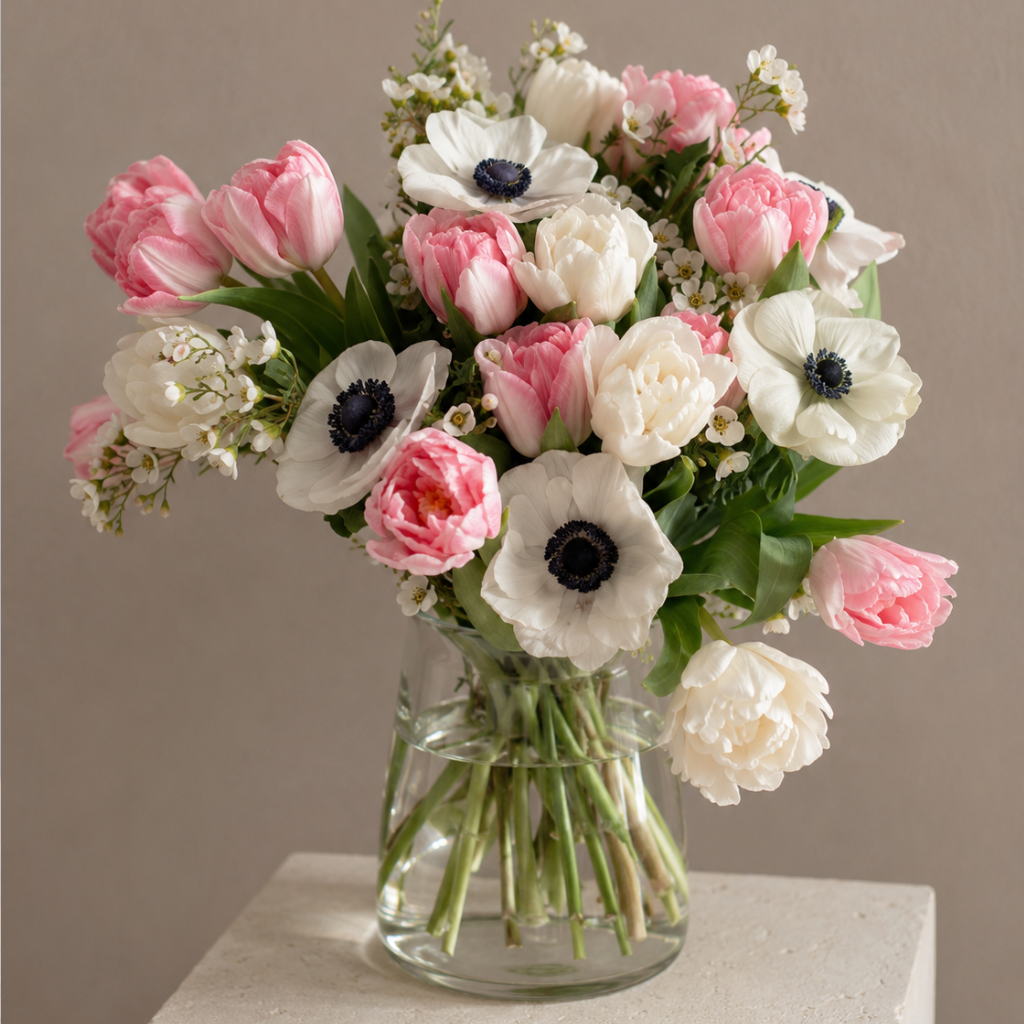 Luxury blush tulips and white anemones arranged in a modern glass vase by BLÜM Miami